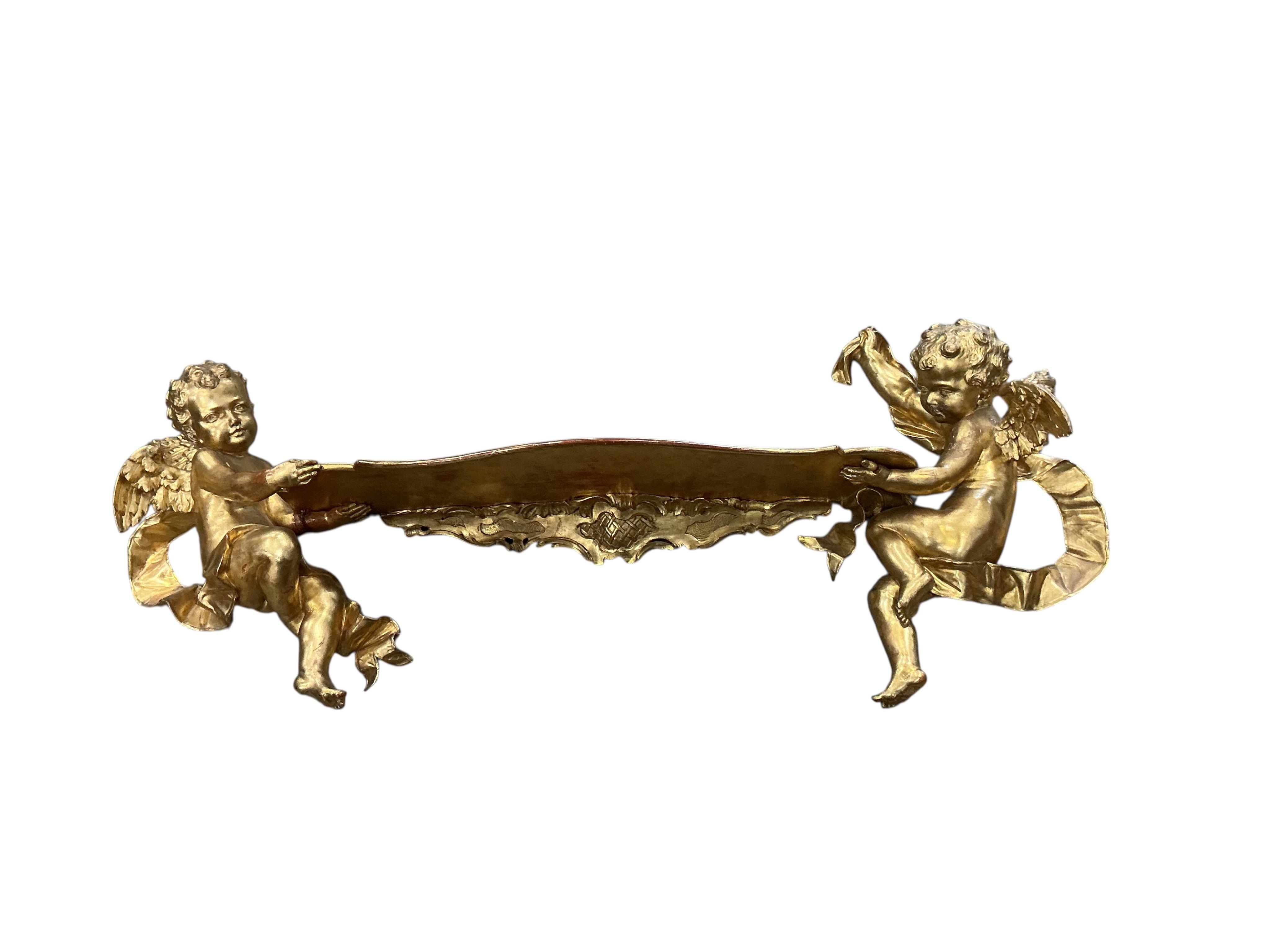 A Victorian style giltwood and composition cherub wall bracket, width 102cm, height 38cm